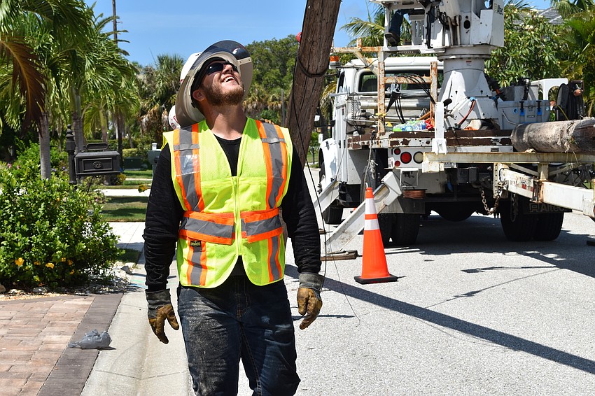 On July 22, Volt Power Co. groundsman Jared Truxillo looked on as workers removed a light pole from Birdie Lane.