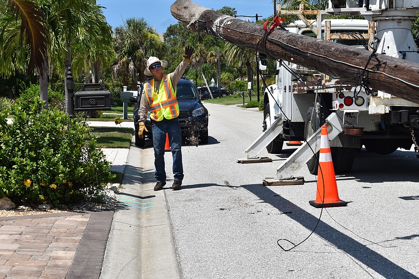 On July 22, Volt Power Co. foreman Jimmy Sasser helped crews load a wooden light pole onto a truck.