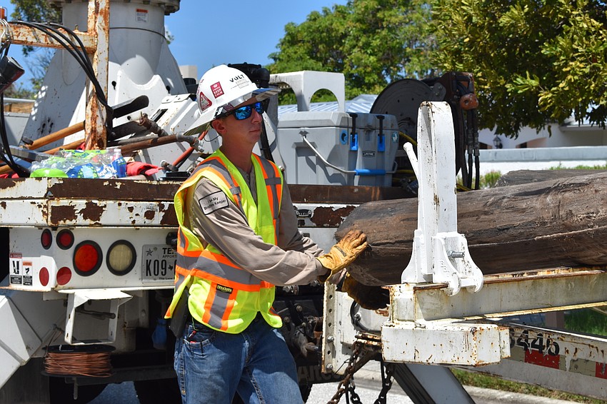 On July 22, Volt Power Co. foreman Jimmy Sasser helped crews load a wooden light pole onto a truck.