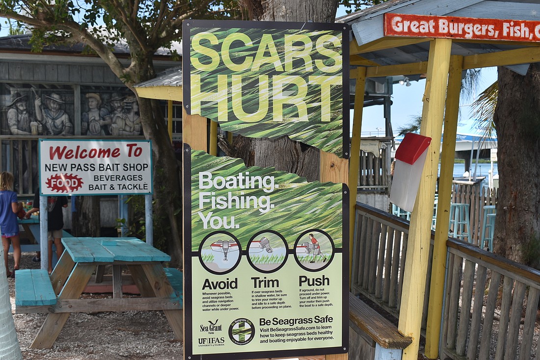 One of Sarasota Bay Estuary Program&#39;s signs is at the New Pass Grill and Bait Shop.