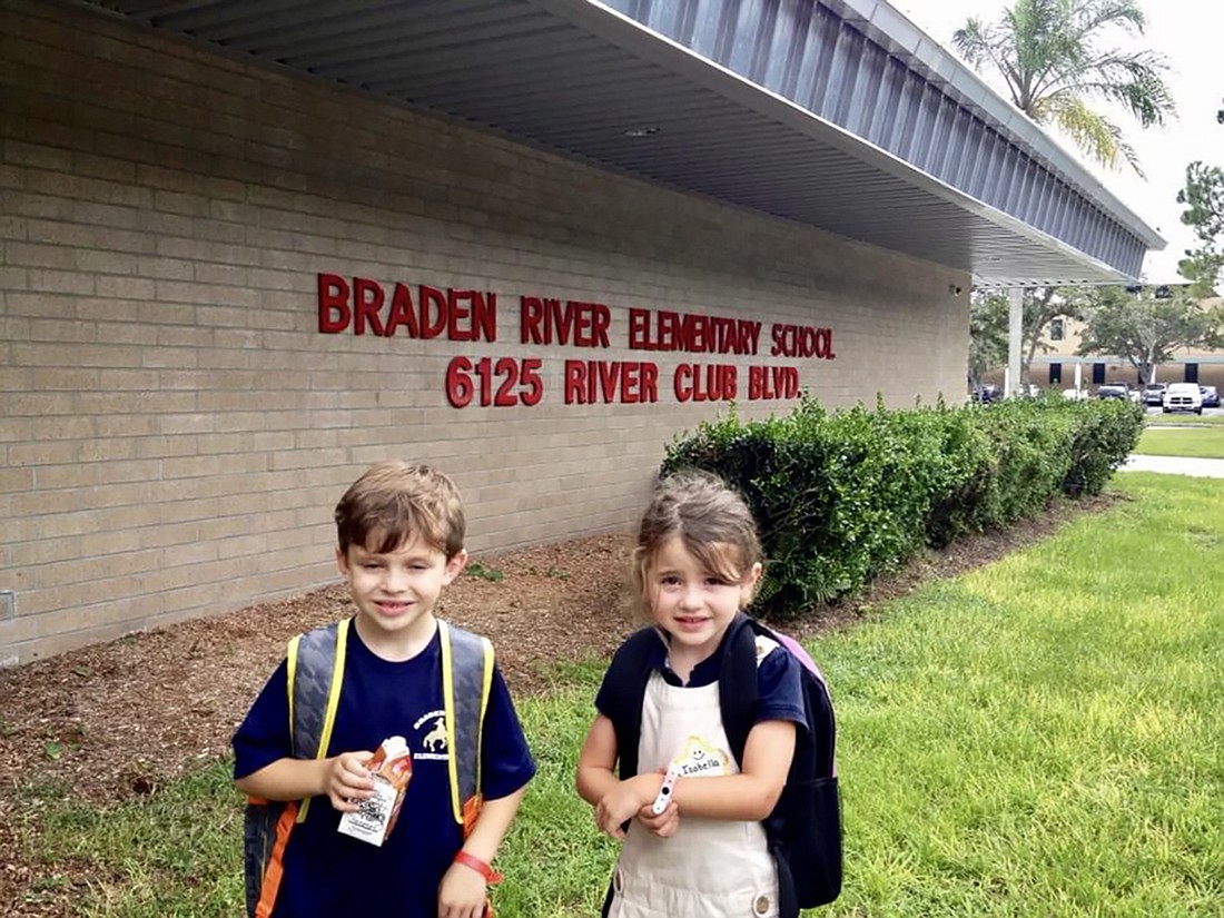 Nicolas Juliano celebrates his first day of first grade at Braden River Elementary while his sister, Isabella Juliano, celebrates her first day of pre-K. The Julianos take a picture on the first day every year. Courtesy photo.