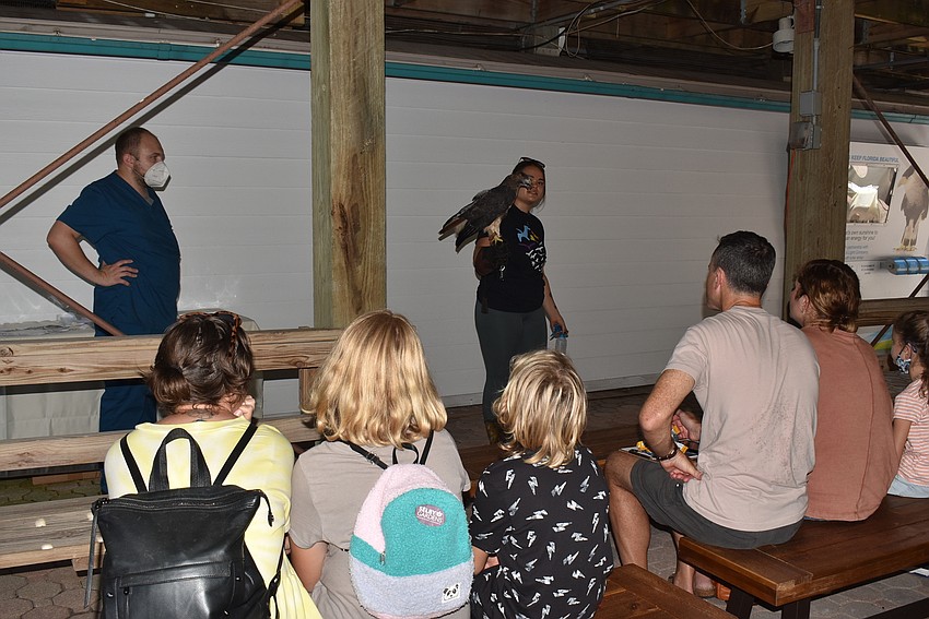 Jonathan Hande and Madilynn Scott give a bird presentation with Buck the red-tailed hawk.
