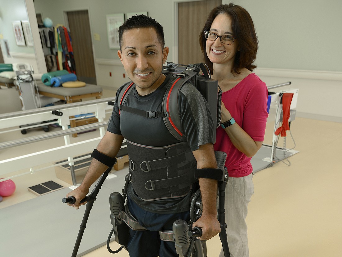 Physical therapist Rebecca Paquette (right) helped a patient use an assistive device. Therapists may recommend assistive devices for helping people return to the activities they enjoy. Photo courtesy of Sarasota Memorial Hospital.