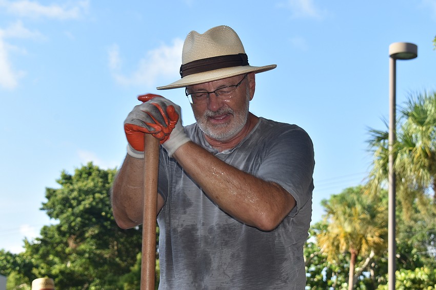 Ron Doerr rests on his shovel after fighting with a root.