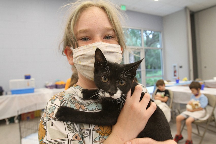 Fiona Konrath, 11 plays with a kitty.