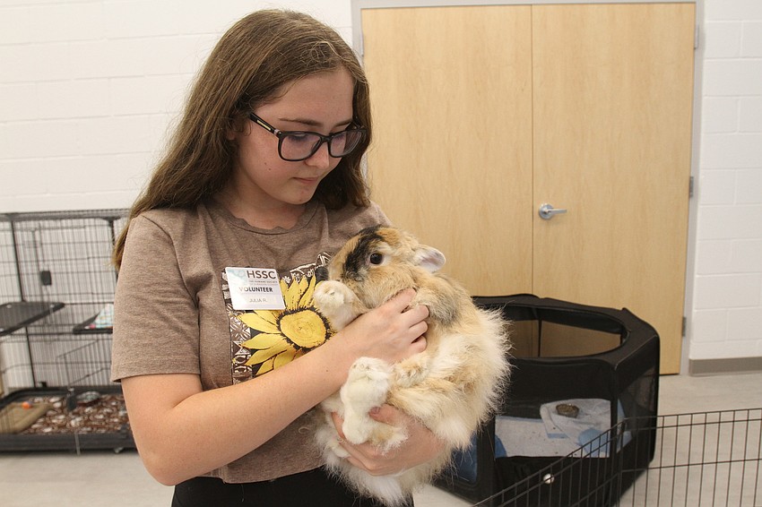 Volunteer Julia Reedy brings out Peaches the rabbit.