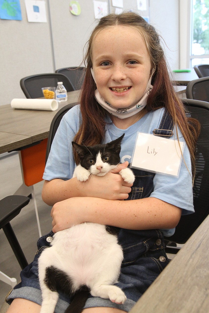 Lilly Allison, 10, takes care of a kitten.