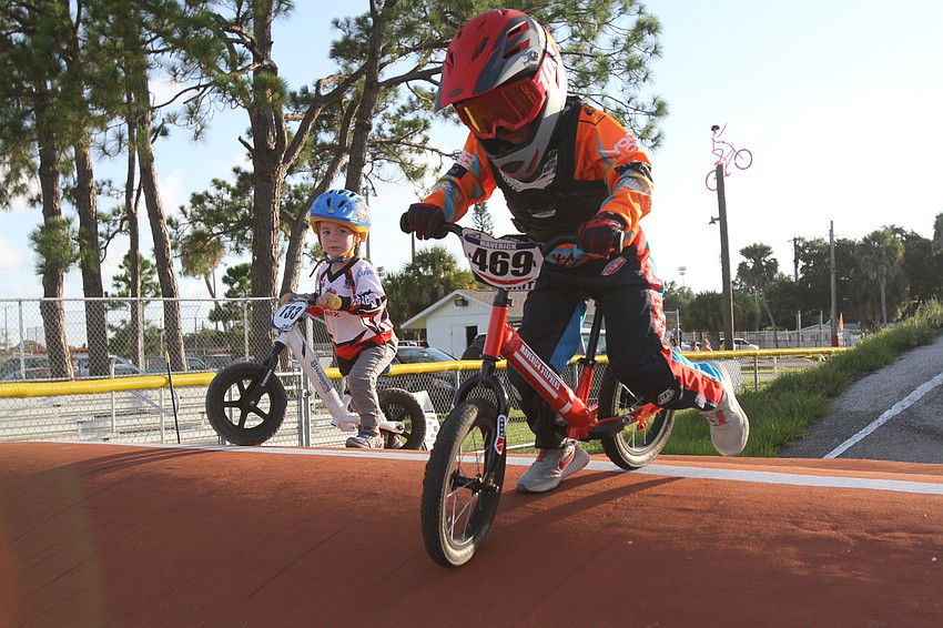 Caiden Cass and Maverick Stephens race along the track.