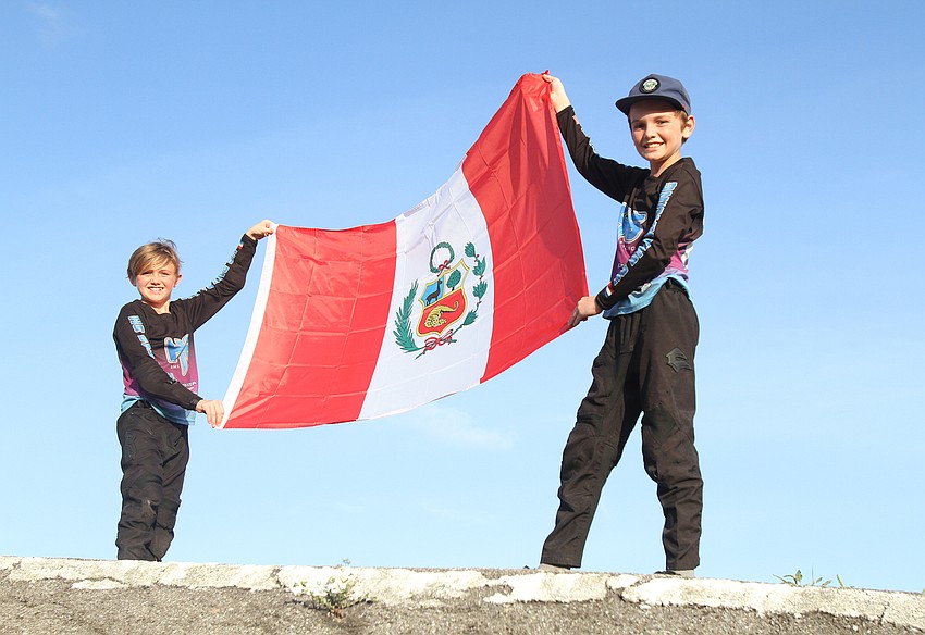 Holden and Hudson Murphy carry Peru's flag.