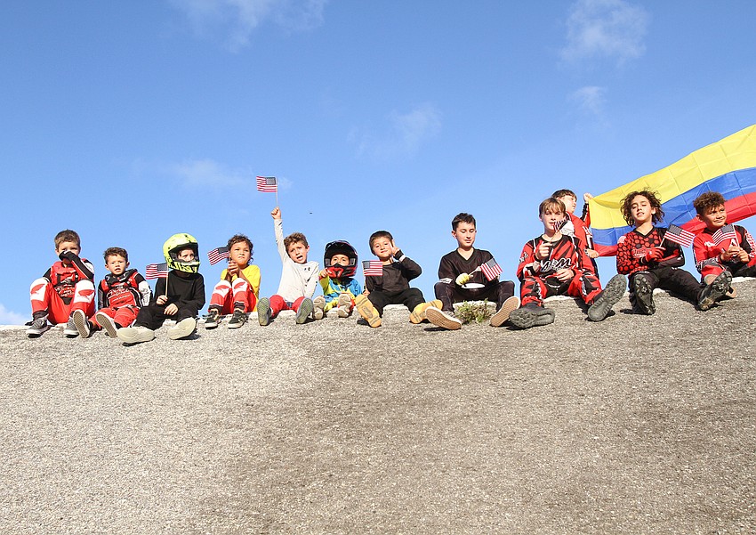 Riders rest on the track before the parade starts.