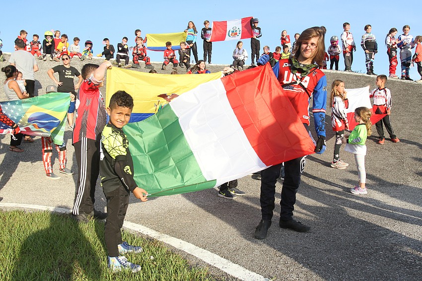 Giuliano Silva and Austin Smith carry the Italian flag.