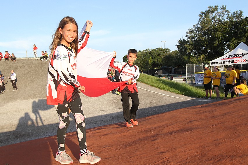 Mikyla and Jason Sobczak carry the Polish flag.