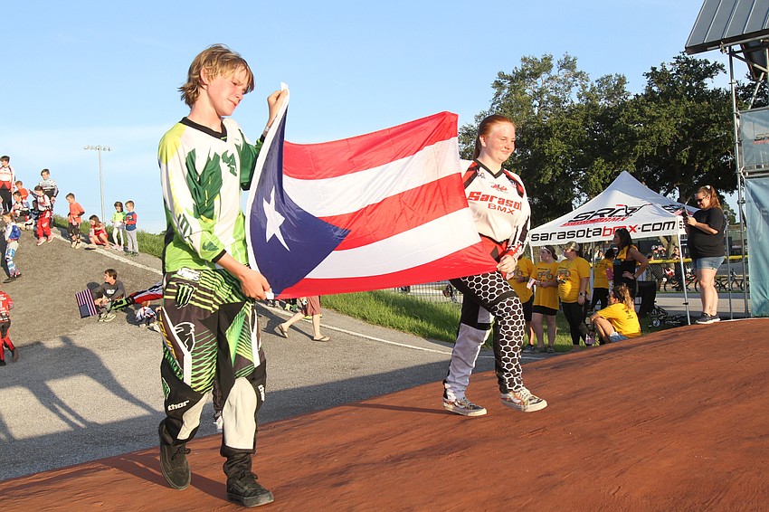 Knox Hammett and Carissa Mulhern march with the Puerto Rican flag.