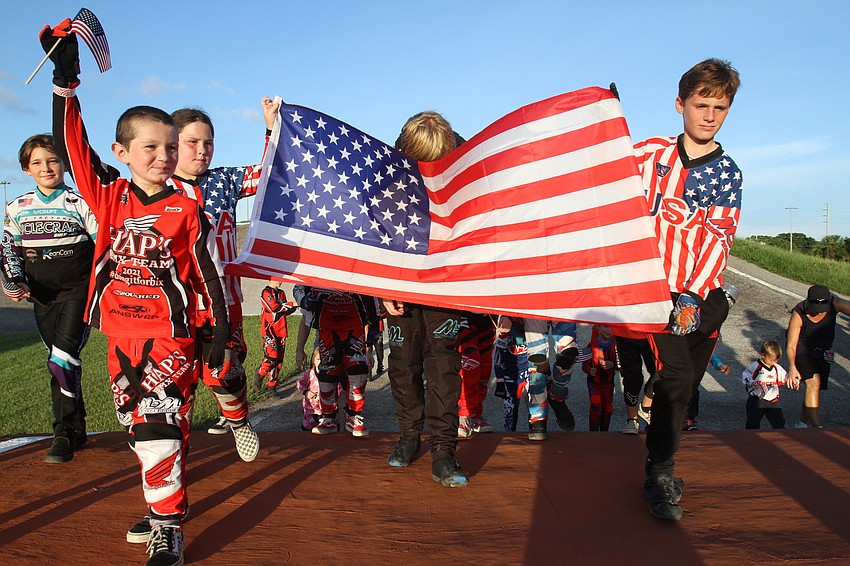 A group marches with the American flag.