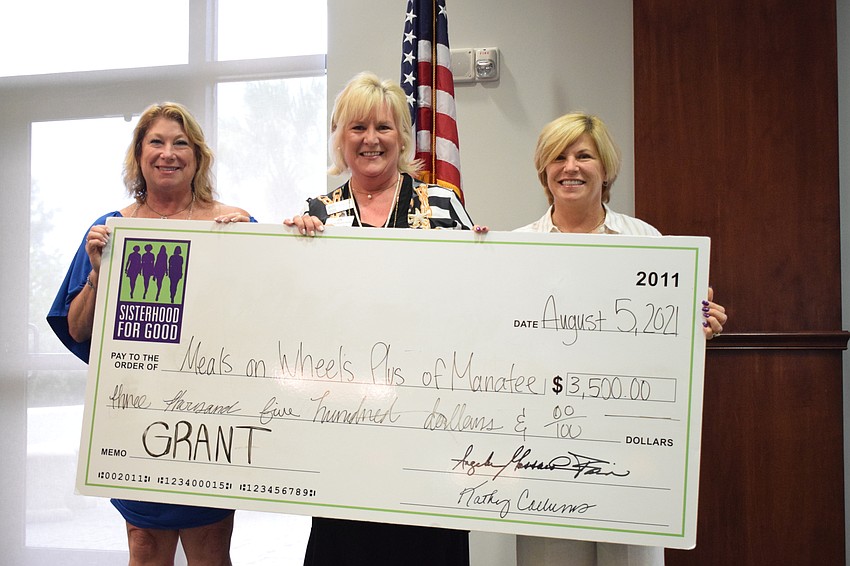 Judi Bjork and Maribeth Phillips with Meals on Wheels Plus of Manatee accepts a $3,500 check from Sisterhood for Good President Angela Massaro-Fain. The grant will be used for Meals on Wheels Plus' Food4Families program