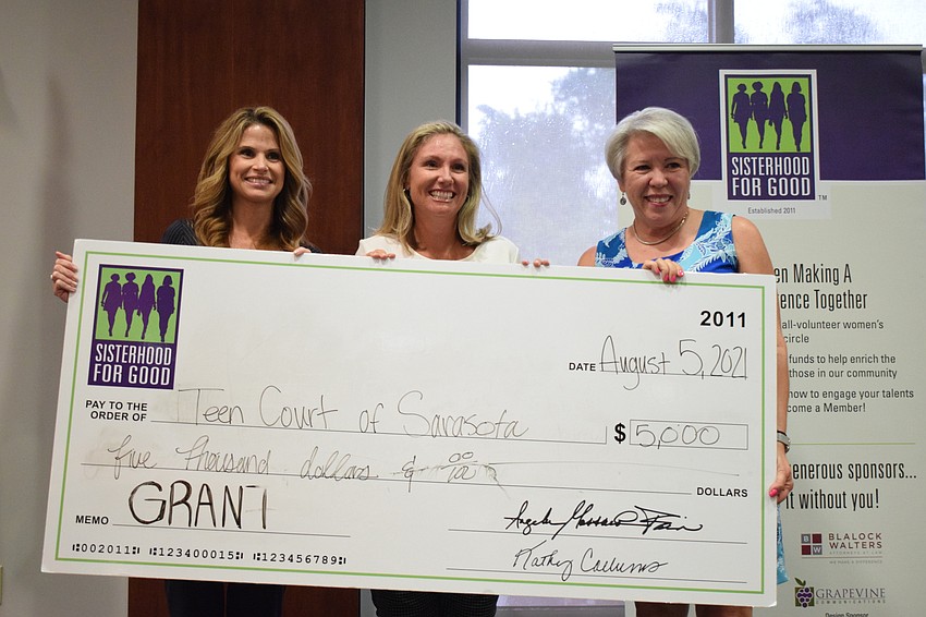 Lori Moran and Heather Todd with Teen Court of Sarasota say the $5,000 grant they accepted from Sisterhood for Good's Terri Stern will help with costs of the Teen Court's camp-substance abuse program for about 160 youth.