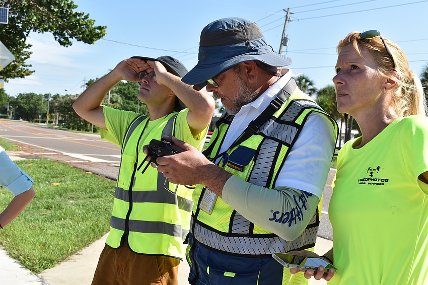 Alex Harkinson, Hjalmar Pachas and Melissa Matisko watch as the DJI Matrice 300 RTK was in the air.