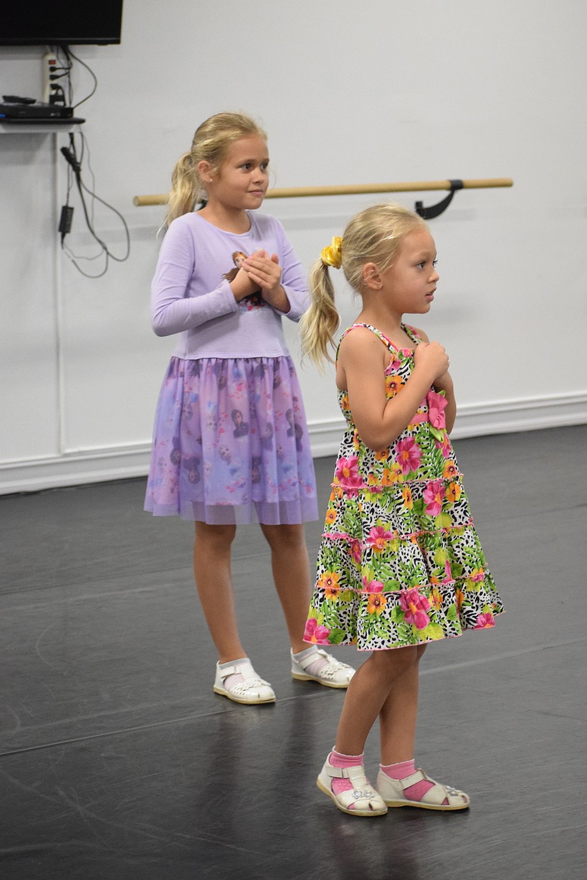 East County's Amelia Shamieva, who is 8, and her 5-year-old sister Alice Shamieva, dance like Elsa from Disney's 