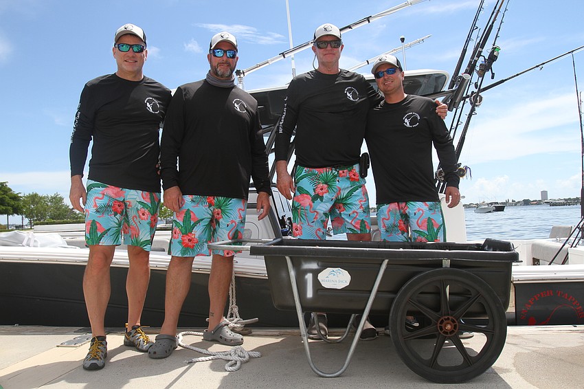 Jim LeBaron, Justin Laurie, Fred Kunkle and Coby Hinkle wear matching shirts and shorts as part of the Snapper Capper.