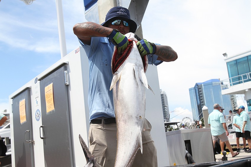 Levi Palacios lifts a fish onto the hook