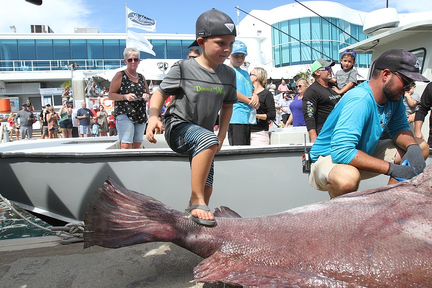 River Froelich stands on his prize.