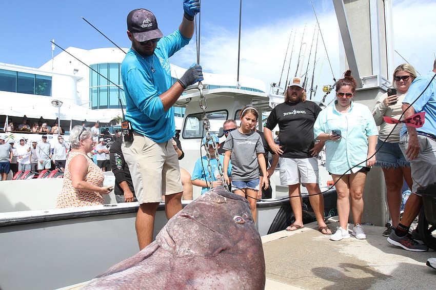 Patrick Lustro raises a 400-pound groper