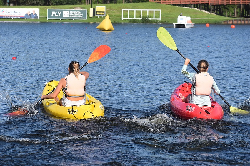 Waterside's Maria Berzins, 12, and Julia Dillingham, 12, compete in the girls kayak race for 11- and 12-year-olds. Berzins said paddleboarding was her favorite part of the camp.