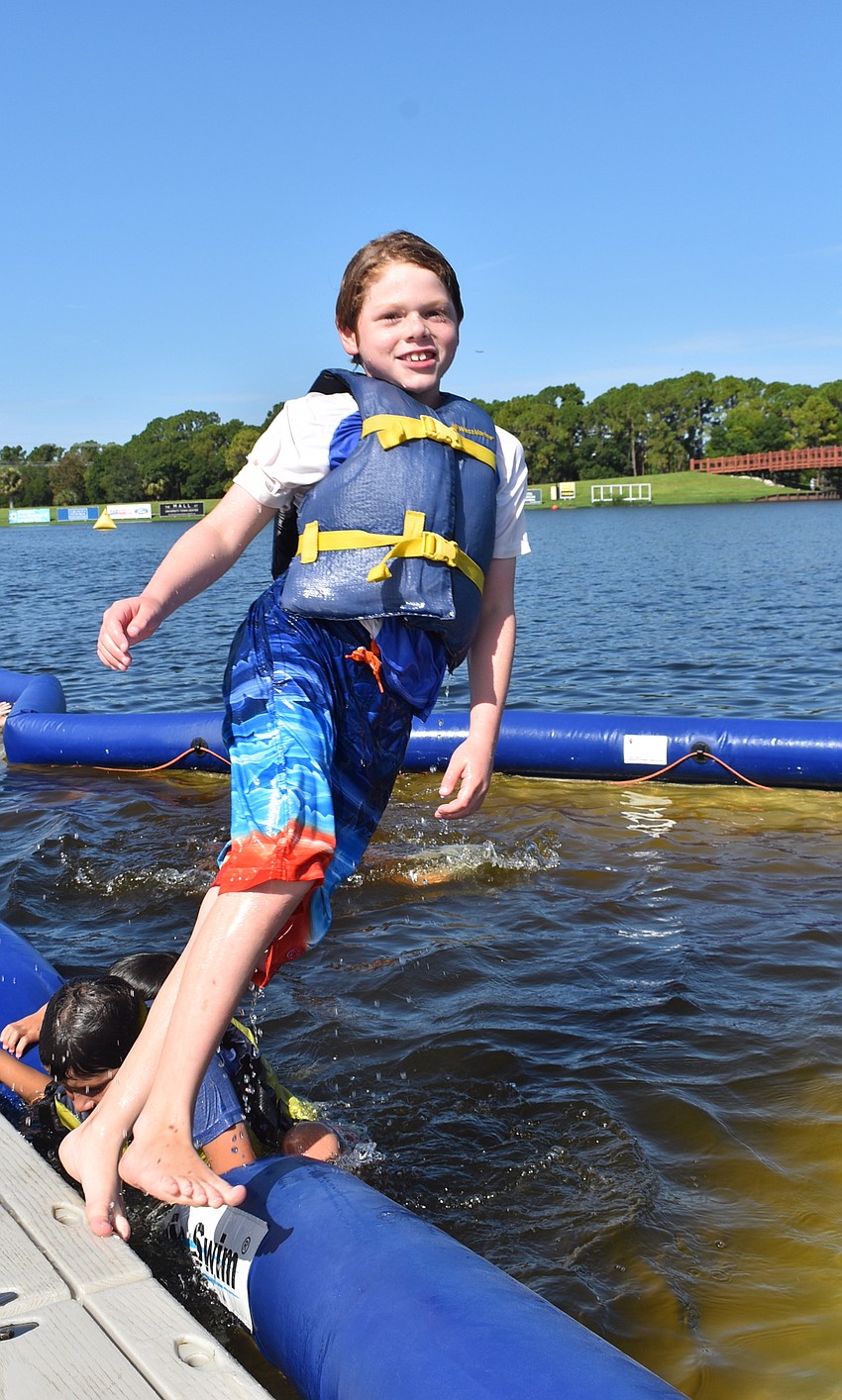 Sarasota's Jake Johnson, 8, enjoys his favorite part of water adventure camp, which was taking turns jumping into the water with his friends.