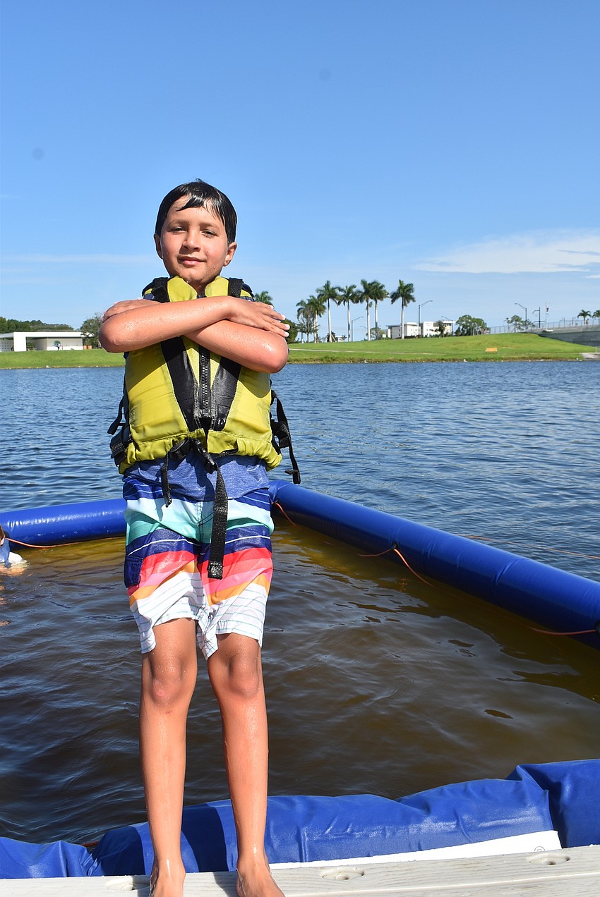 Sarasota's Lorenzo Romero, 9, braces himself for the fall into the swimming pool at the end of a hot morning. His favorite activity was riding the paddleboards.