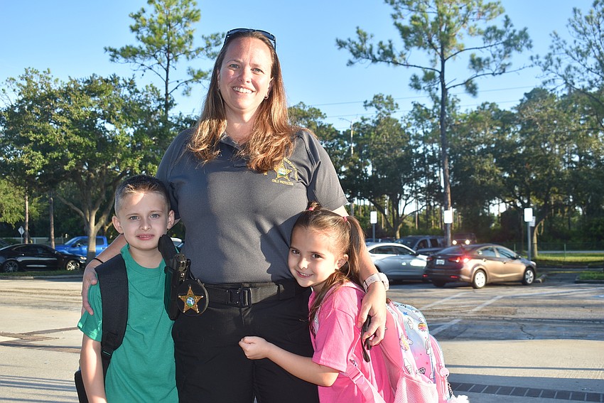 First grader Wesley Wildt, mom Melanie Wildt and kindergartner Isabella Wildt are ready for a new school year at Tara. Melanie Wildt is happy her kids could learn without masks.