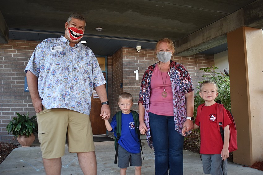 Parents Craig and Vanessa Embry drop off twin kindergarteners Parker and Warren Embry at Tara Elementary School. Parker Embry says he's excited for recess, while Warren Embry wants to make new friends.