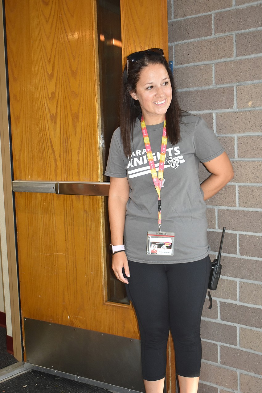 Varying exceptionalities teacher Kimber Spreeman holds the door open to let kids filter into Tara Elementary School classrooms for the first day.