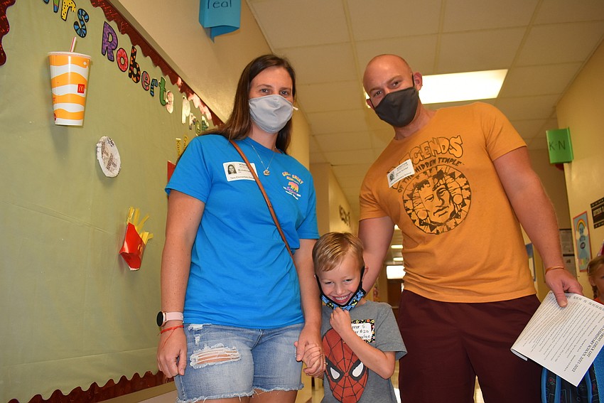 Parents Michelle and Derek Schlipf stand outside the classroom where Connor Schlipf will attend his first day of kindergarten at Tara Elementary School.