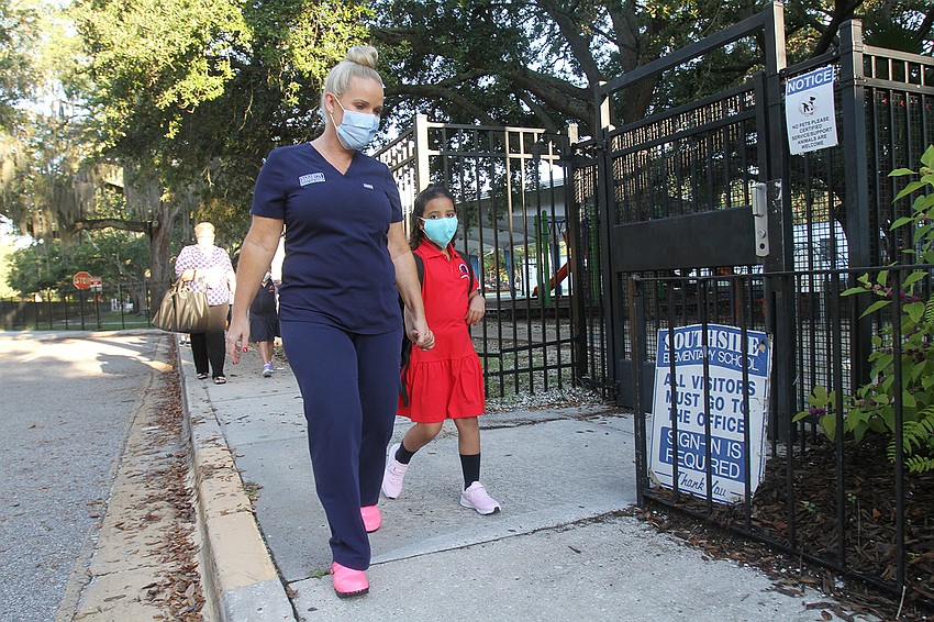 Nicole McClain walks Skyla Littles to school for her first day of kindergarten at Southside Elementary School.