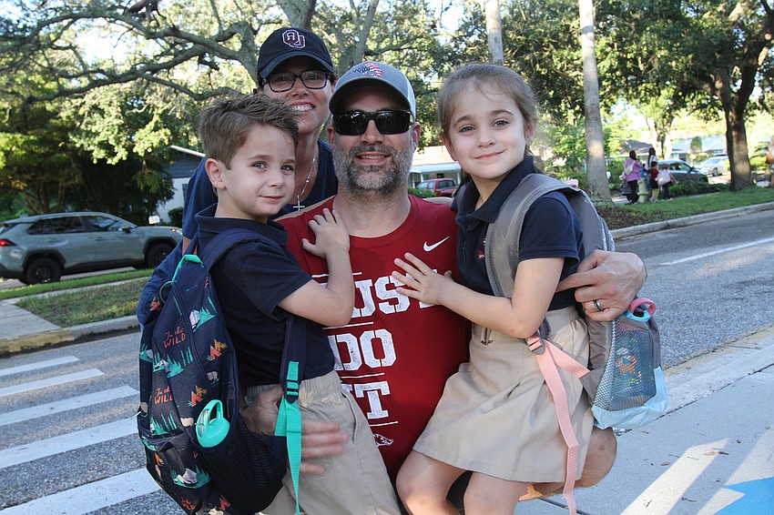 Teresa and Justin DeWitt give their children Piece and Violet a big hug before they start kindergarten at Southside Elementary School.
