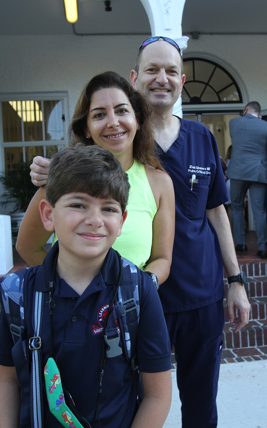 Ramzi, Jidane and Ziad Ghamra take photos outside of Southside Elementary School.