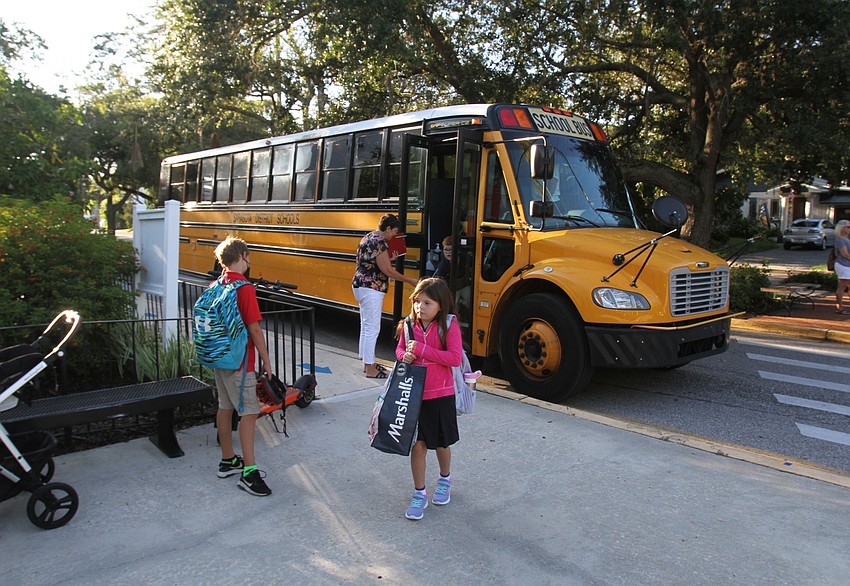 Students leave the bus for their first day of school at Southside Elementary School.