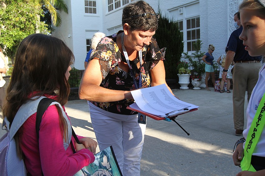 Paraprofessional Trish Faulkner directs children to their classrooms at Southside Elementary School.