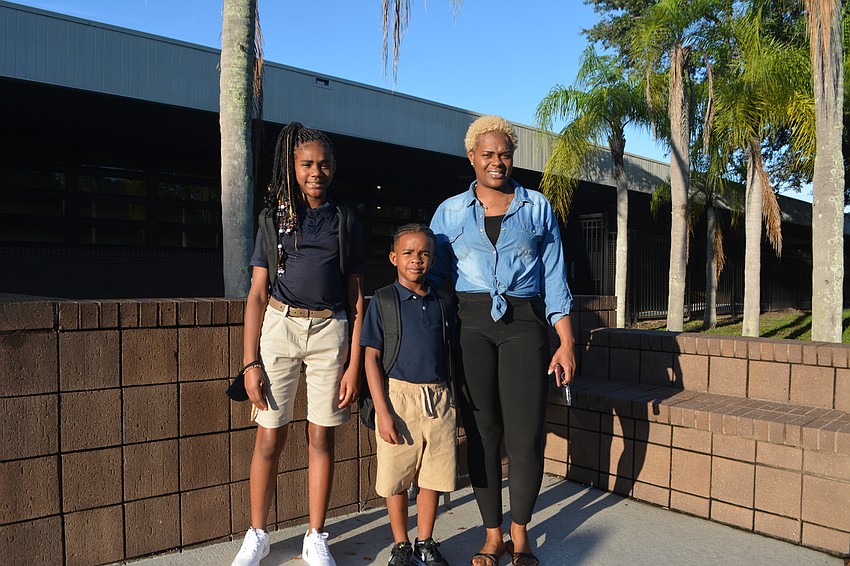 Jeffiana and Jeffrie Gambles, 10 and 7, were accompanied to Emma E. Booker Elementary School by Marie Walker.