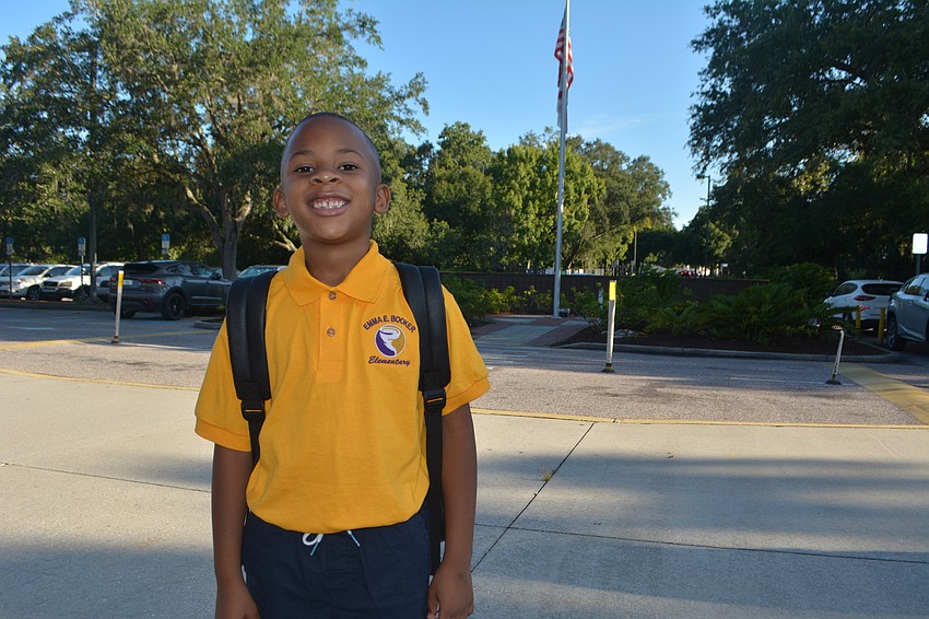 Jerron Bell, 6, smiles after arriving at Emma E. Booker Elementary for the first day of school.