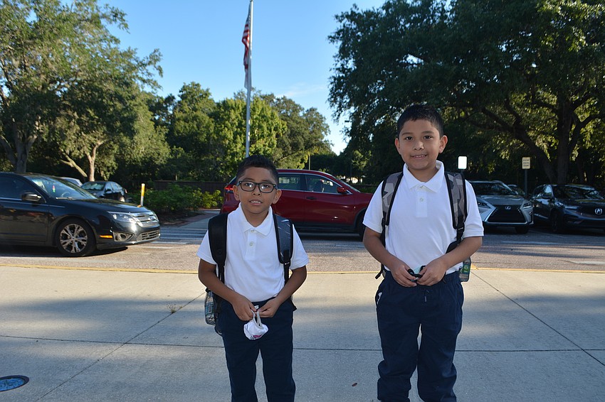 Booker Elementary students Justin and Jorge Ramirez, 6 and 8, head into Emma E. Booker Elementary School in the morning.