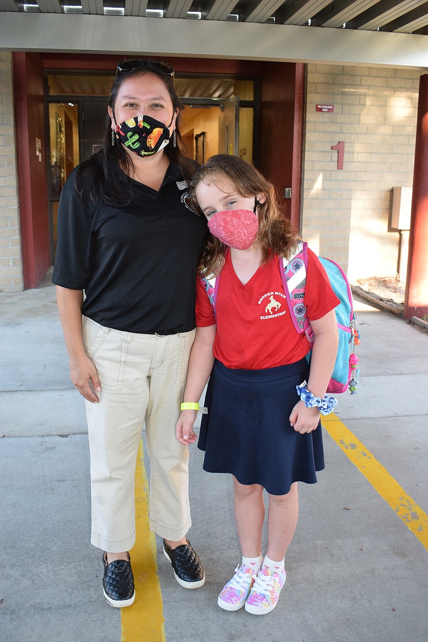 Abigail Williams walks her daughter, Abrianna Williams, to her second grade classroom.