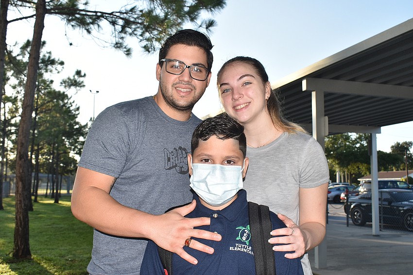 Yosander and Jaiden Perry with third-grader Kevin Ramirez at Tuttle Elementary School.