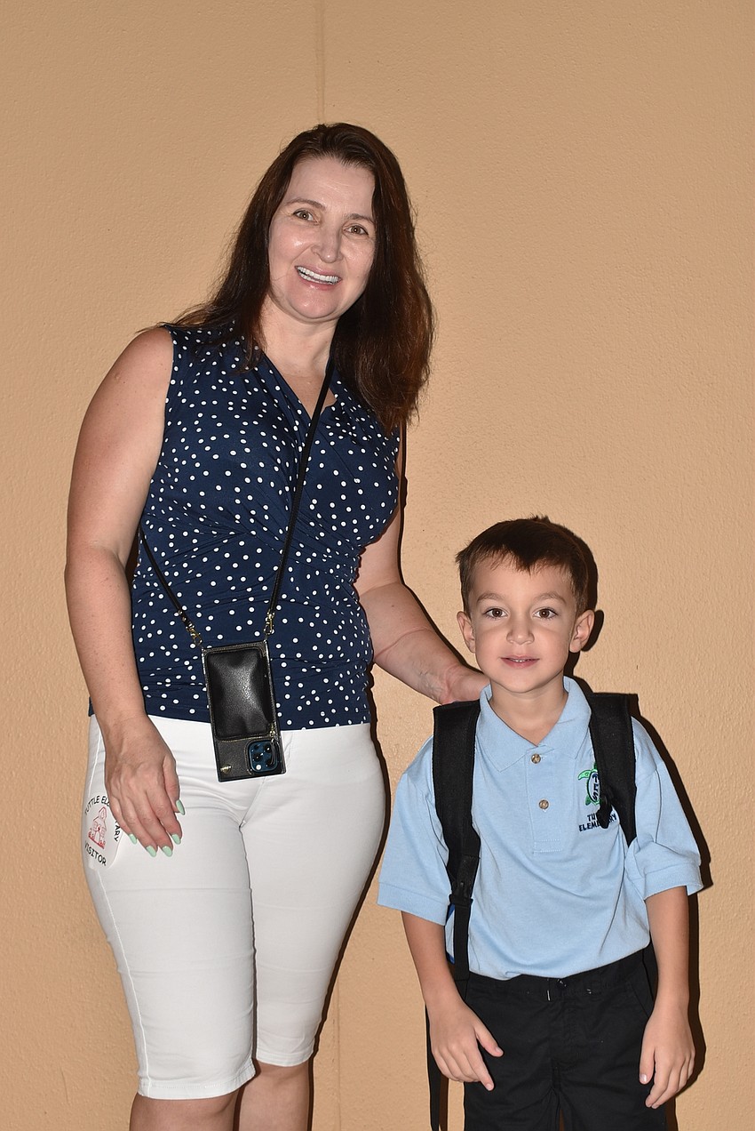 Oksana and 5-year-old Simon Zuraev head to Simon's kindergarten class at Tuttle Elementary School.