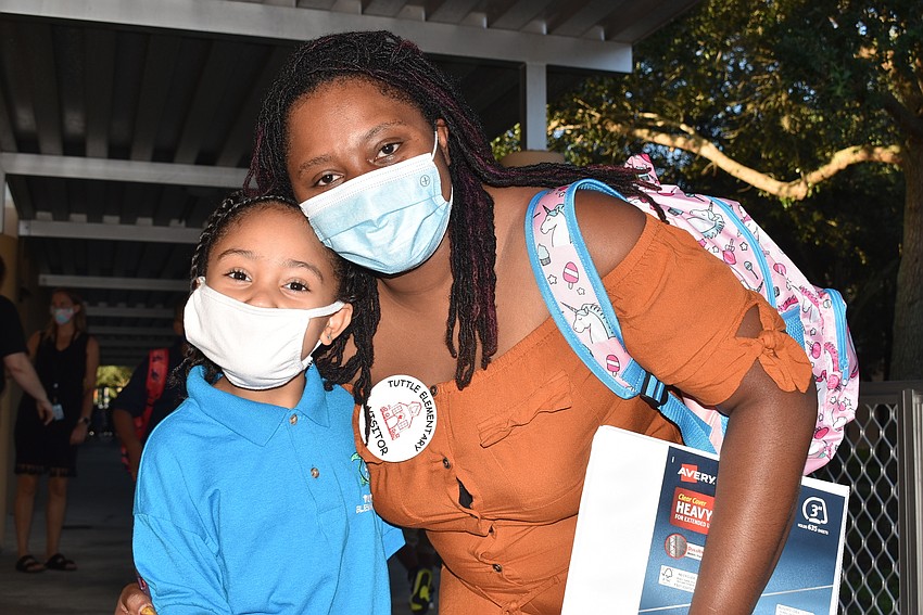 5-year-old Tiana Haywood walks with mom Reva Kates to her kindergarten class at Tuttle Elementary School.