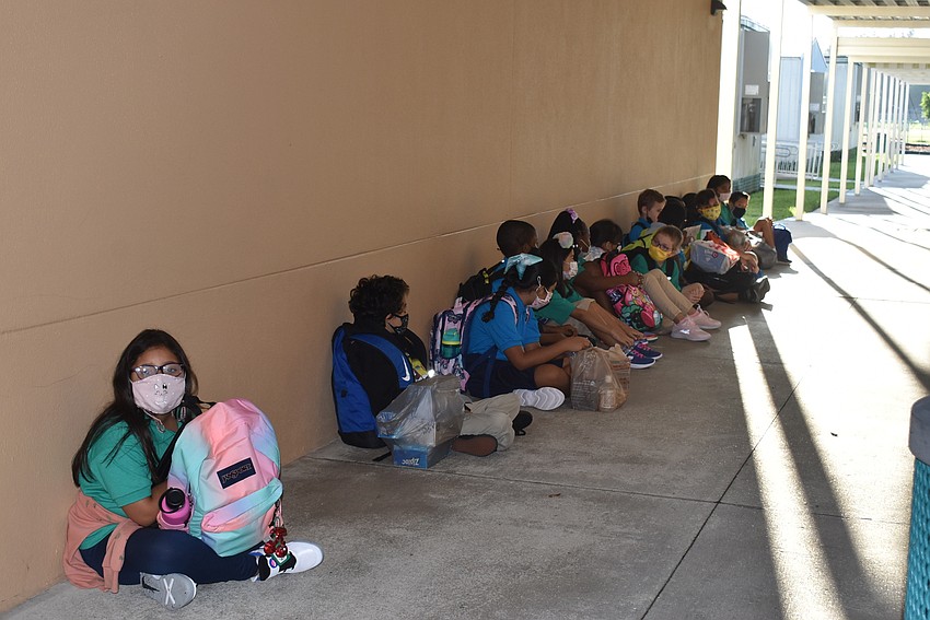 Kids wait for their teacher to head into class at Tuttle Elementary School.