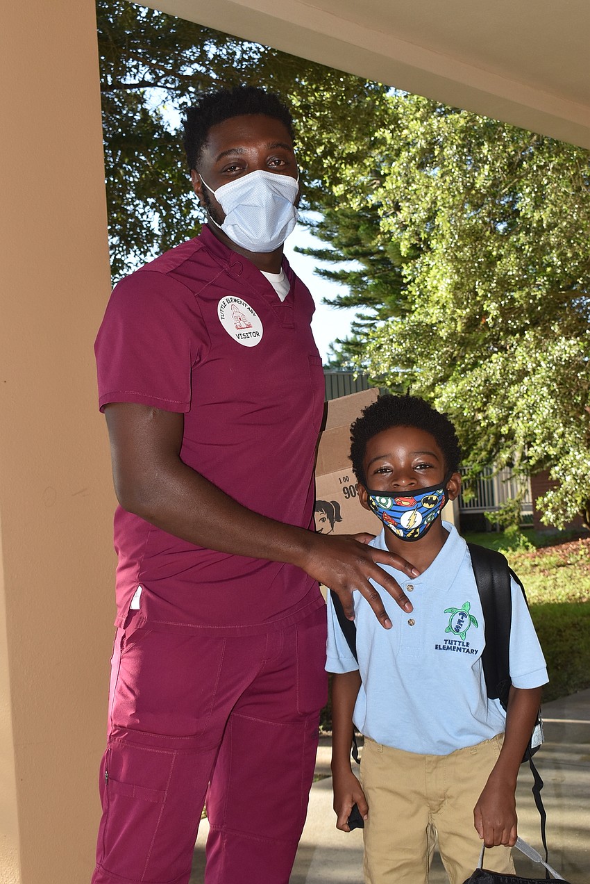 Vincent Jr. and Vincent III Gordon head to the third-grade wing of the Tuttle Elementary School.