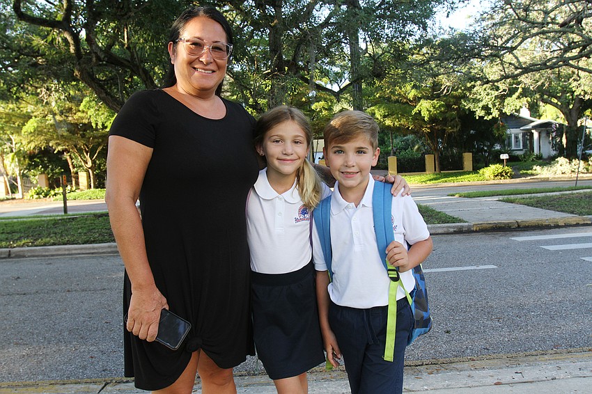 Marcia Van Ginhoven walk her children Grace and Carson to Southside Elementary School.
