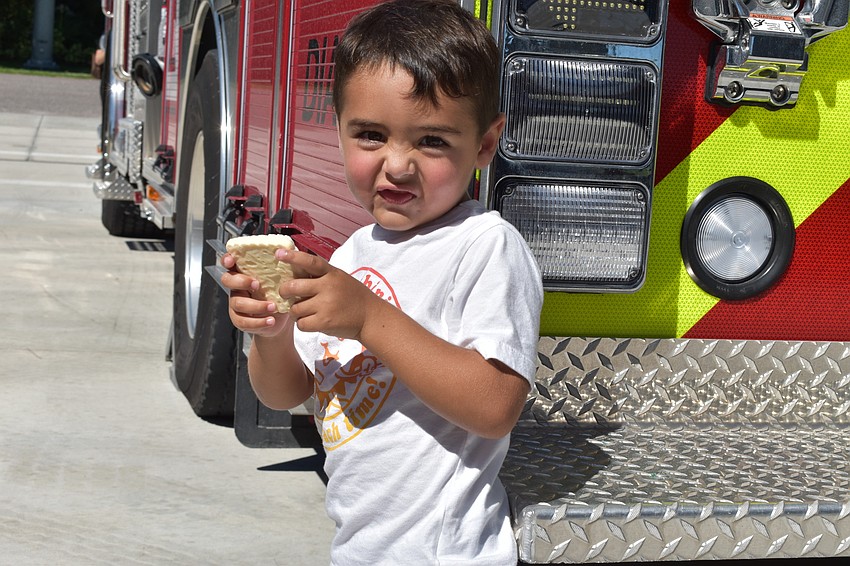 Jimmey Romanoff, 3, was on his way to school when his dad saw the Fire Station 92 grand opening. His dad called him out of school to attend Wednesday's ceremony.