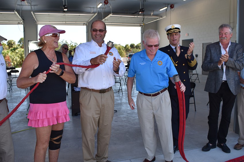 At-Large Commissioner BJ Bishop, Town Manager Tom Harmer and Mayor Ken Schneier take part in Wednesday's uncoupling of the firehose. Fire Chief Paul Dezzi and Vice Mayor Mike Haycock look on.